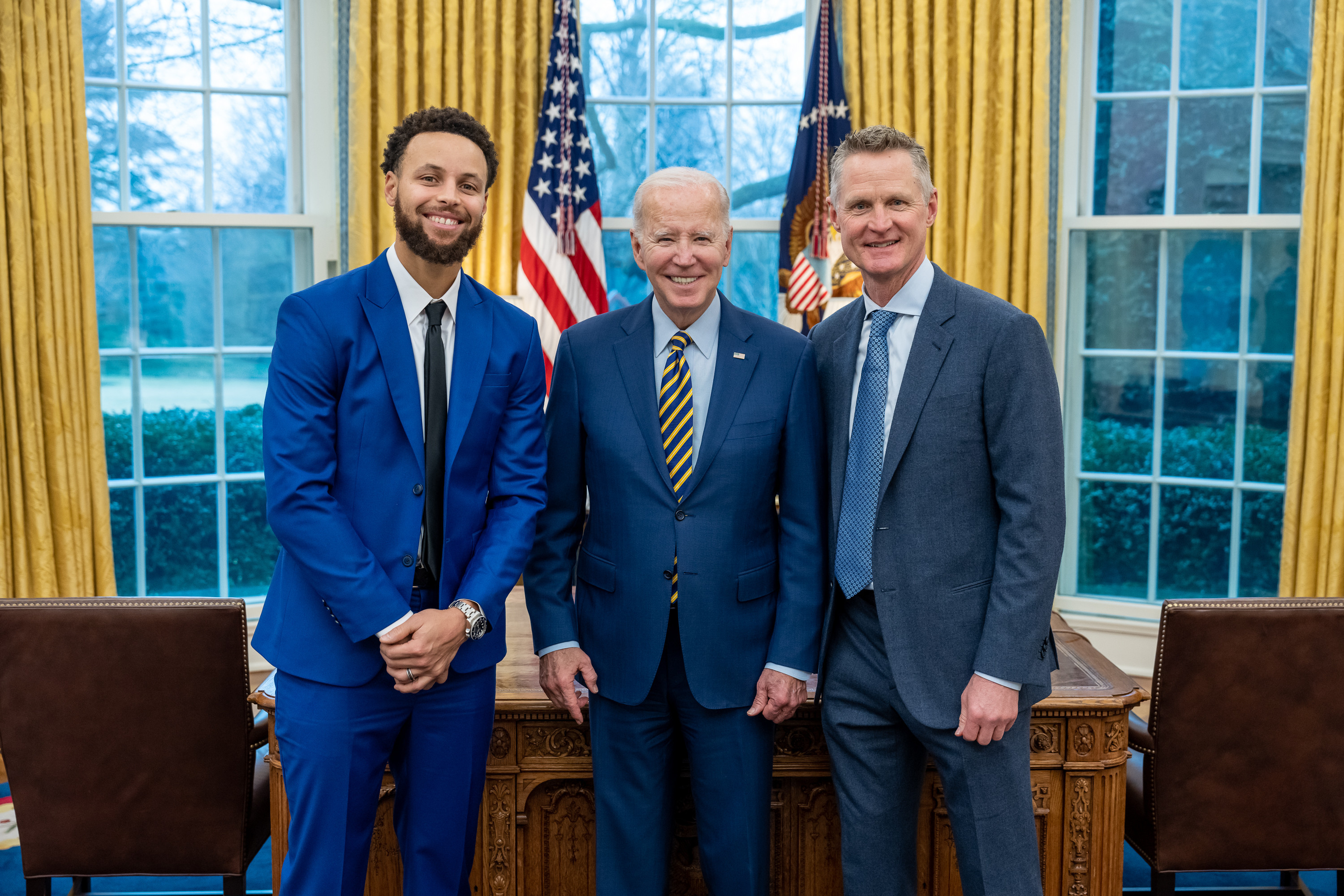 Photo of President Joe Biden with Golden State Warriors guard Steph Curry (left) and head coach Steve Kerr (right) on Jan. 17, 2023, before an event celebrating the team’s 2022 NBA championship.