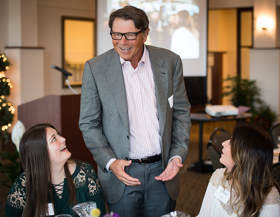 David Novak smiling and talking with students