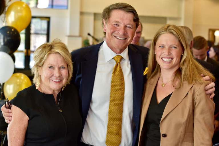 David Novak and family smile at the gift announcement ceremony