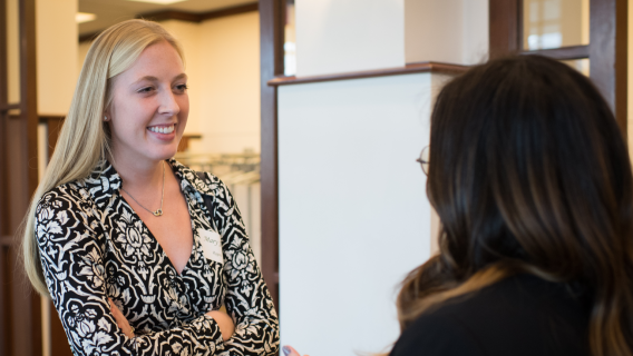 Photo of Novak Leadership Institute student consulting a peer.