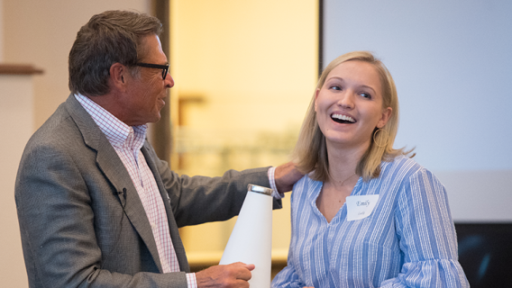 Photo of David Novak recognizing a student