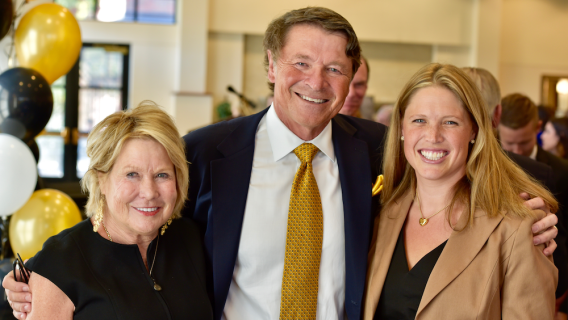 David Novak and family smile at the gift announcement ceremony